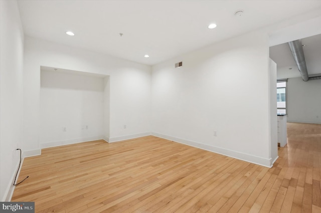 unfurnished room with light hardwood / wood-style floors