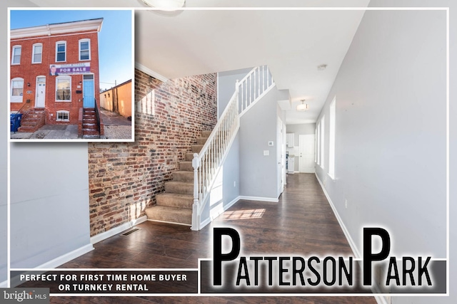 stairway featuring hardwood / wood-style flooring, brick wall, and plenty of natural light