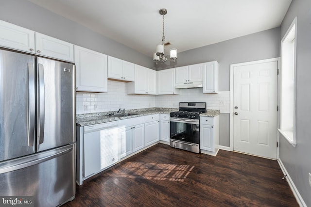 kitchen featuring sink, white cabinetry, appliances with stainless steel finishes, dark hardwood / wood-style floors, and light stone countertops