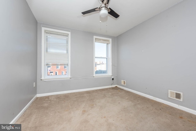 carpeted spare room with ceiling fan