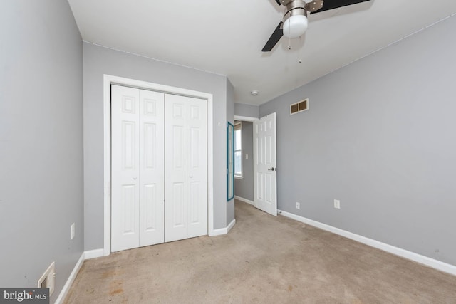 unfurnished bedroom with light carpet, a closet, and ceiling fan