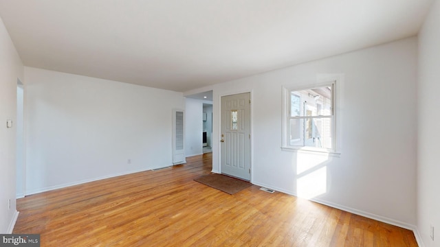 unfurnished room with light hardwood / wood-style floors