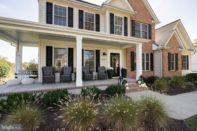 view of front of property with a porch and brick siding