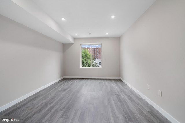 unfurnished room with wood-type flooring