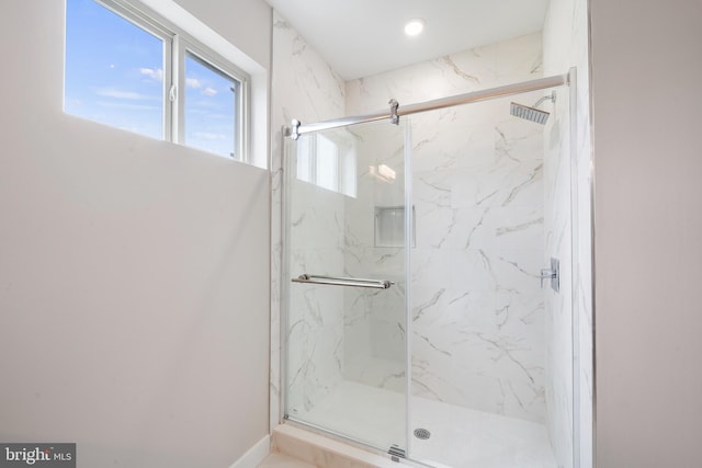 bathroom with a shower with shower door