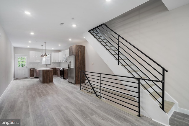 interior space featuring sink and light hardwood / wood-style flooring