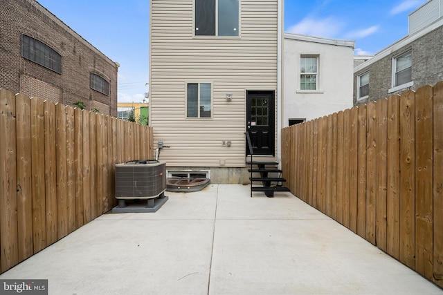 back of property with a patio and central air condition unit