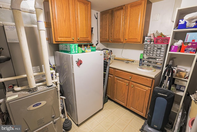 kitchen with heating unit and white fridge