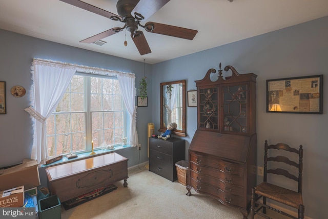 interior space featuring ceiling fan and carpet flooring