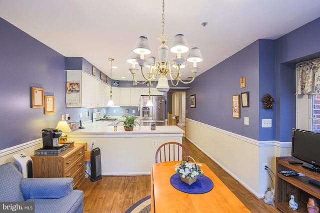 dining room featuring wood-type flooring and a notable chandelier