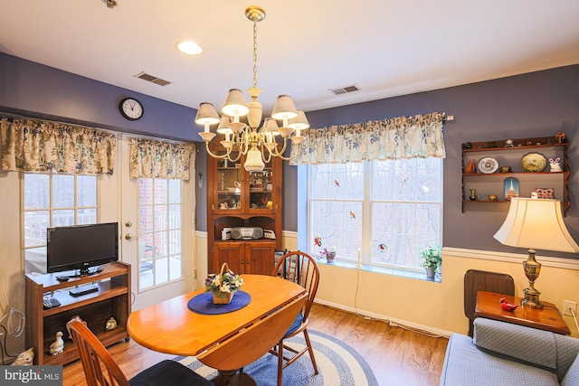 dining room featuring an inviting chandelier and wood-type flooring