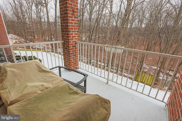 view of snow covered back of property