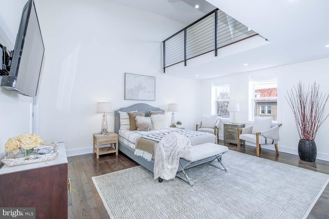 bedroom with dark hardwood / wood-style floors