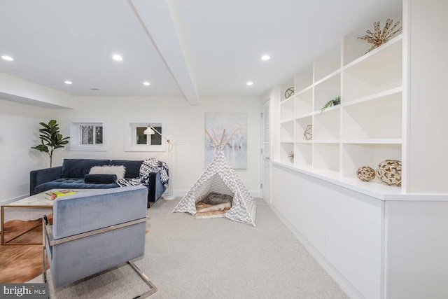 interior space featuring beamed ceiling, light colored carpet, and built in features