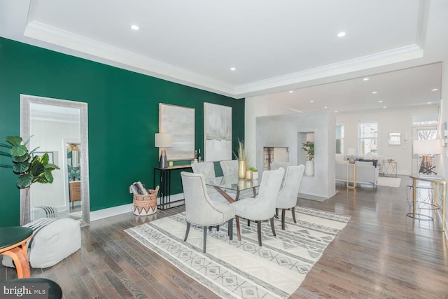 dining space featuring crown molding and dark wood-type flooring