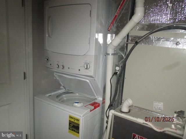 laundry area featuring stacked washer / dryer