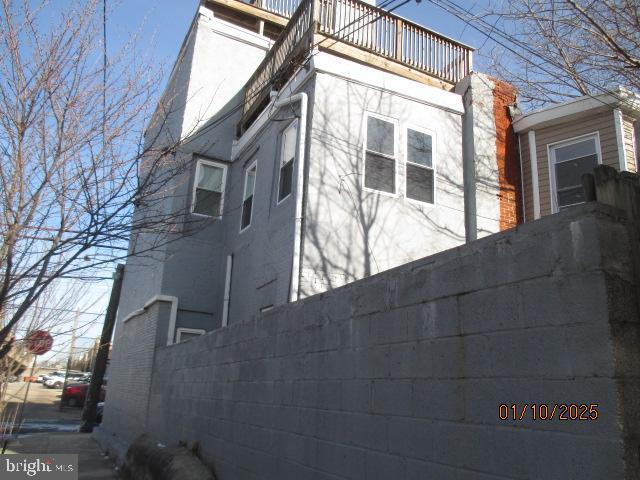 view of side of home with a balcony