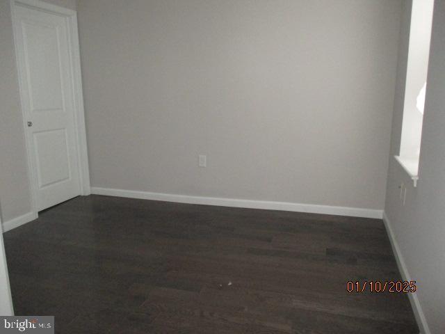 spare room featuring dark hardwood / wood-style floors