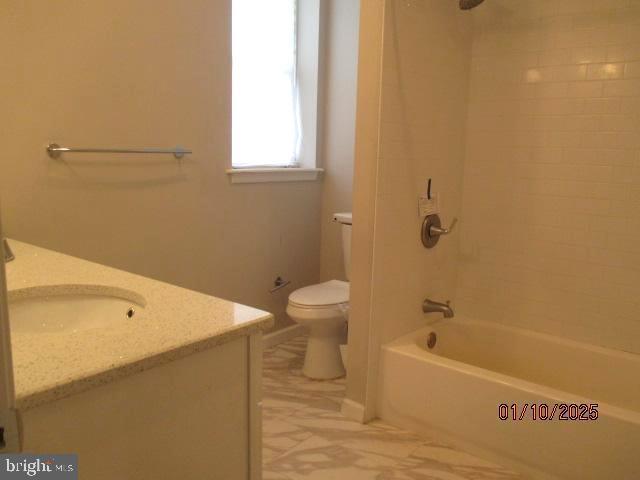 full bathroom with vanity, toilet, and tiled shower / bath combo