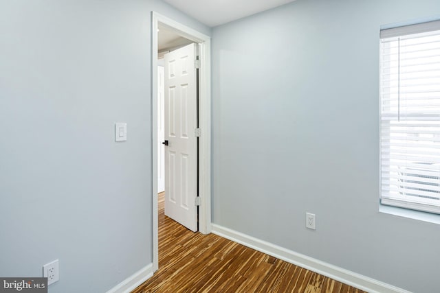 corridor featuring dark wood-type flooring