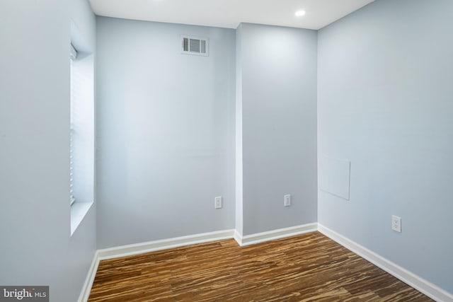 unfurnished room with dark hardwood / wood-style floors