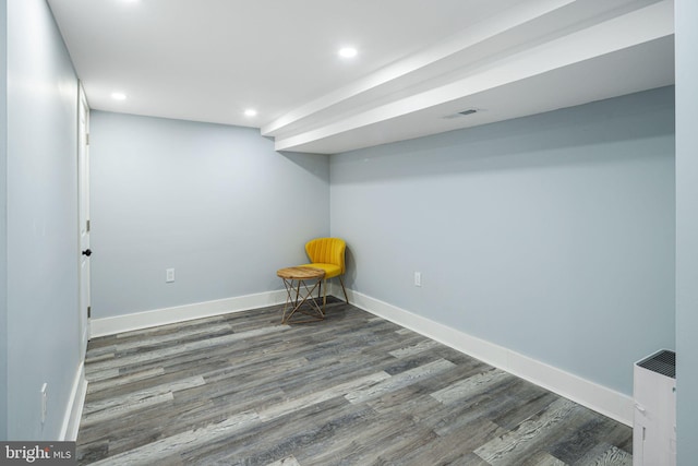 basement featuring dark hardwood / wood-style floors and radiator