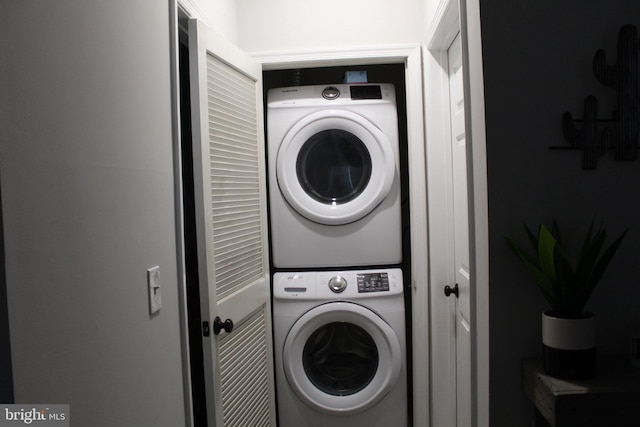 laundry room with stacked washer / dryer