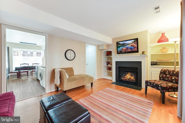 living room featuring washer / clothes dryer and hardwood / wood-style floors