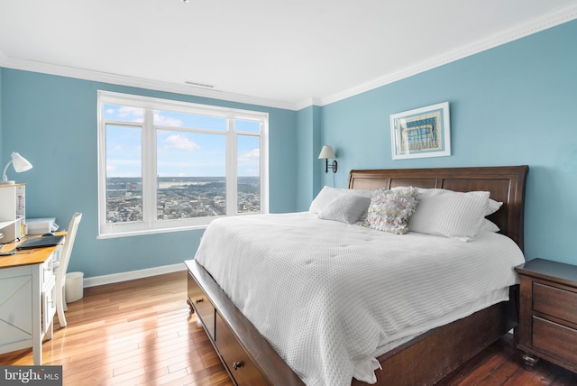 bedroom featuring crown molding and hardwood / wood-style floors