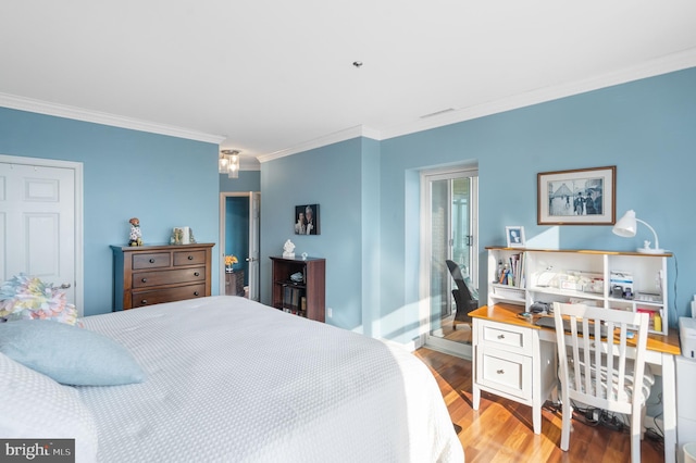 bedroom with ornamental molding and light hardwood / wood-style floors