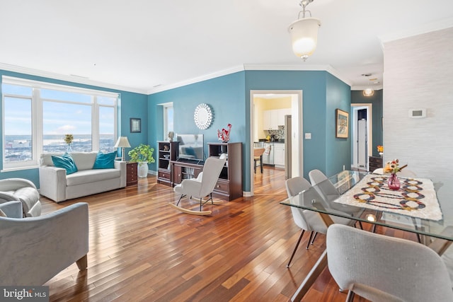 living room with crown molding and hardwood / wood-style floors