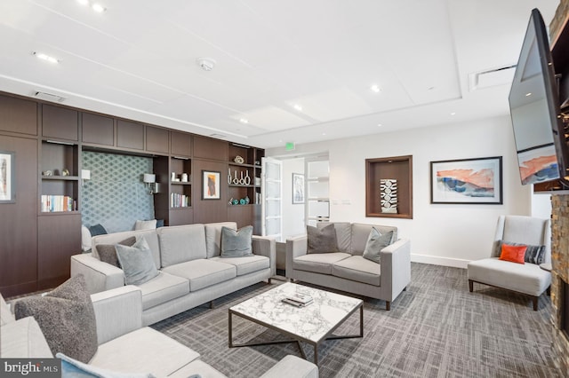 carpeted living room featuring built in shelves