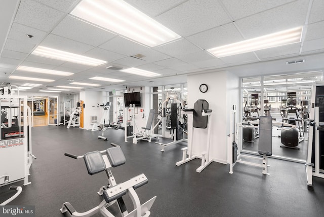 gym featuring a paneled ceiling