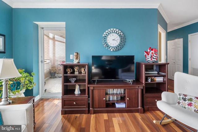 living room with ornamental molding and light wood-type flooring