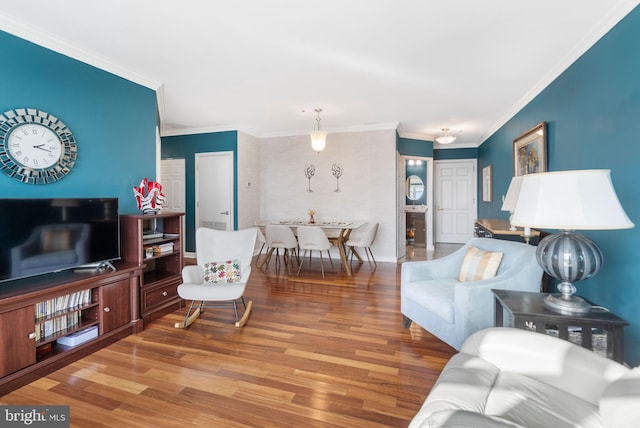 living room with crown molding and hardwood / wood-style floors