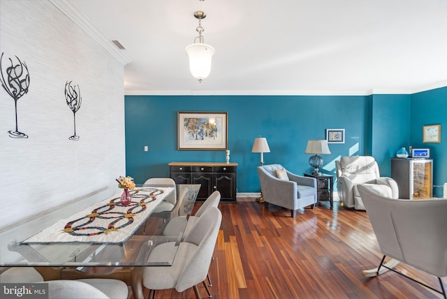 dining area featuring crown molding and dark hardwood / wood-style flooring