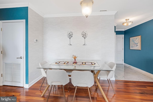 dining room featuring crown molding and hardwood / wood-style flooring