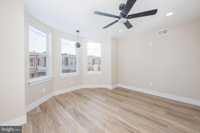 unfurnished room with ceiling fan and light wood-type flooring