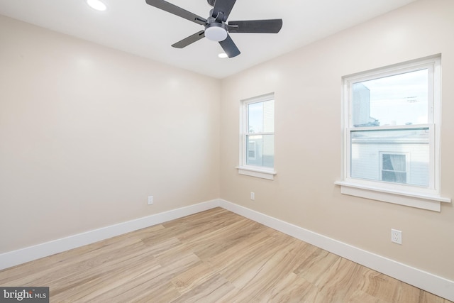 empty room featuring ceiling fan and light hardwood / wood-style flooring