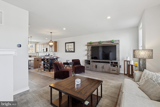 living room featuring a wealth of natural light and wood-type flooring