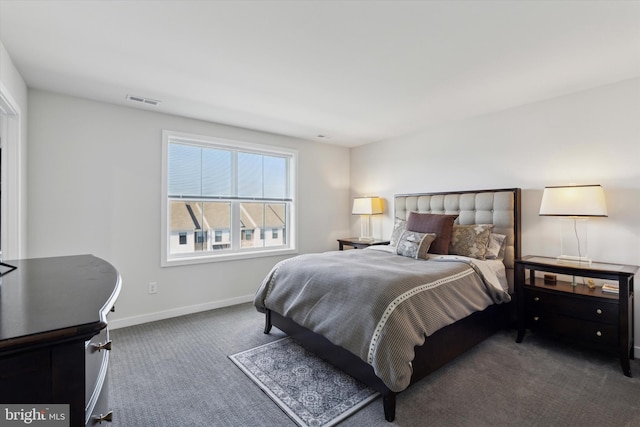 bedroom with dark colored carpet