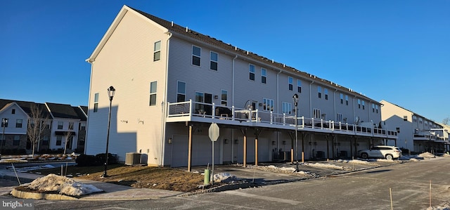 view of property with a garage and central AC