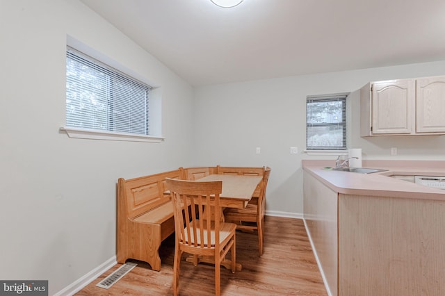 dining room with sink and light hardwood / wood-style flooring