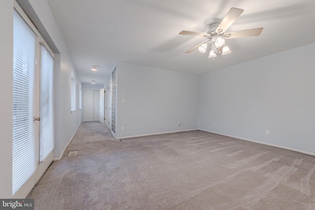 carpeted empty room with ceiling fan