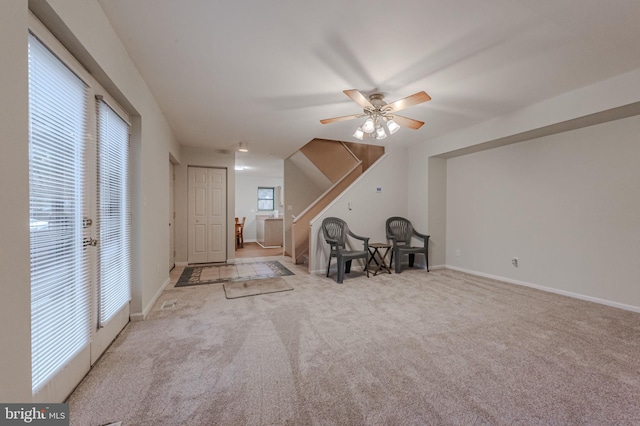 interior space with light carpet and ceiling fan