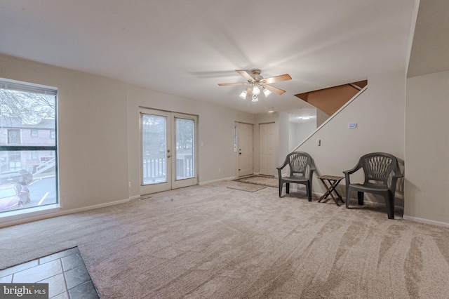 unfurnished room featuring light colored carpet, french doors, and ceiling fan