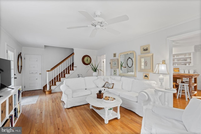 living room with ceiling fan and light wood-type flooring