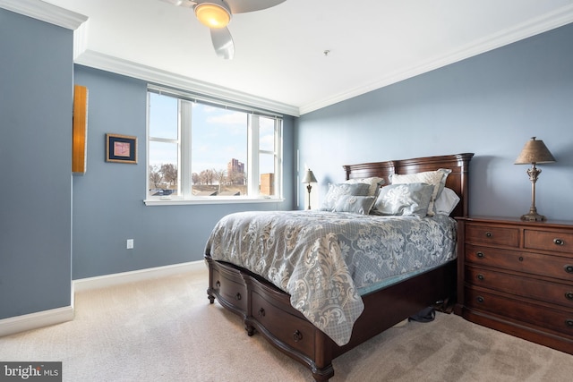 bedroom with ornamental molding, light colored carpet, and ceiling fan