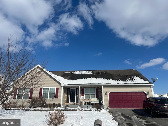 view of front of property with a garage and covered porch