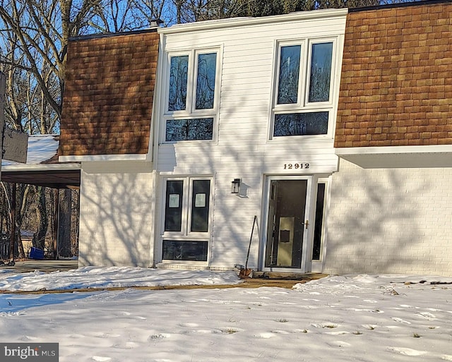 view of snow covered property entrance